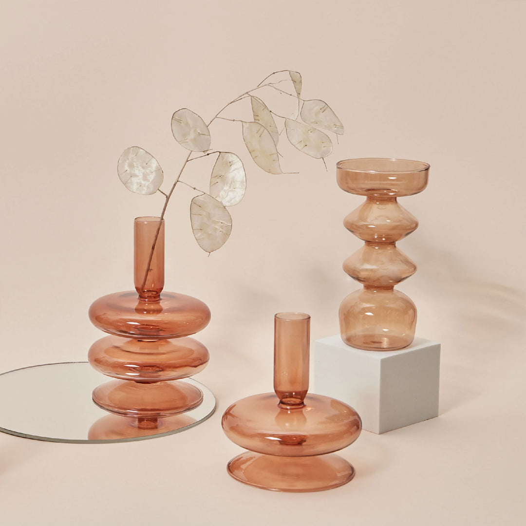 Glass Candlestick Holder collection brings an ornamental and abstract touch to your tabletops and mantelpiece.